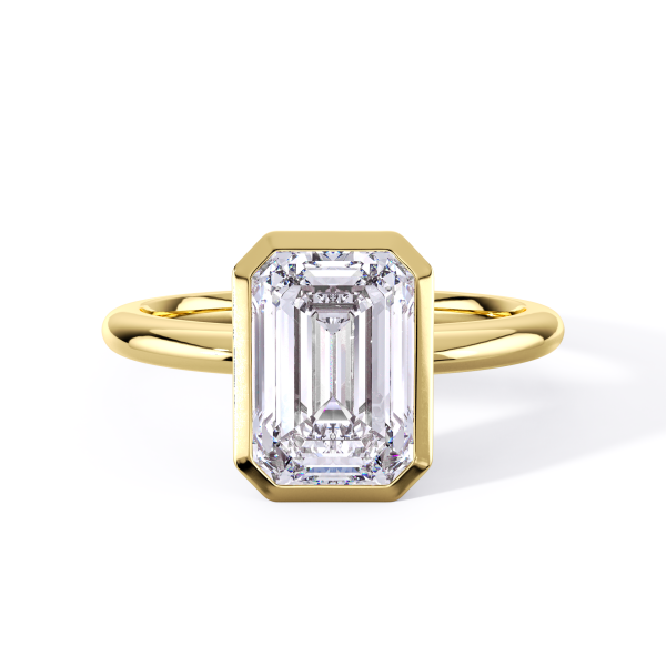 classic bezel solitaire with yellow gold metal and emerald shape diamond