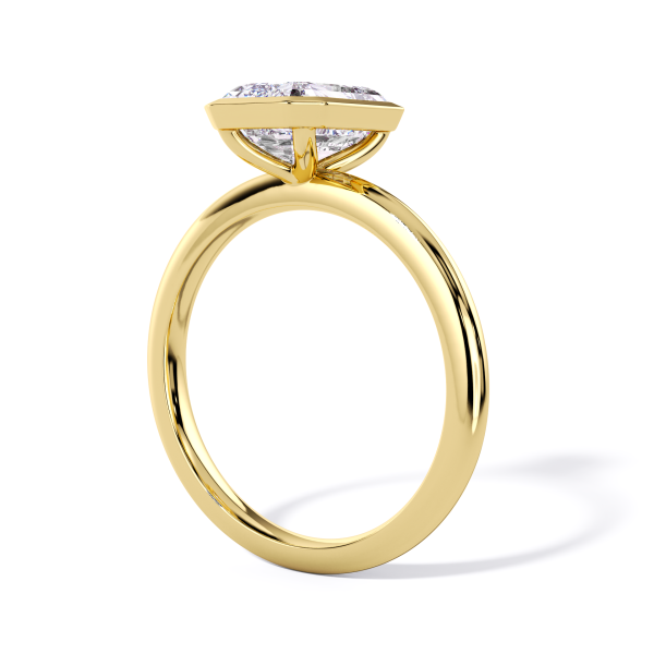 classic bezel solitaire with yellow gold metal and emerald shape diamond